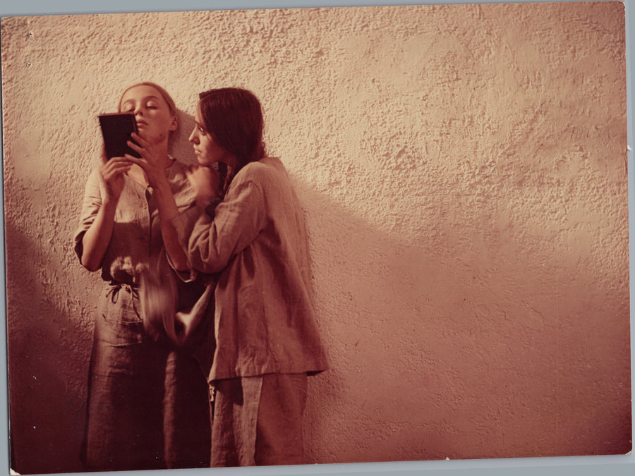 Two People Examining a Handheld Camera