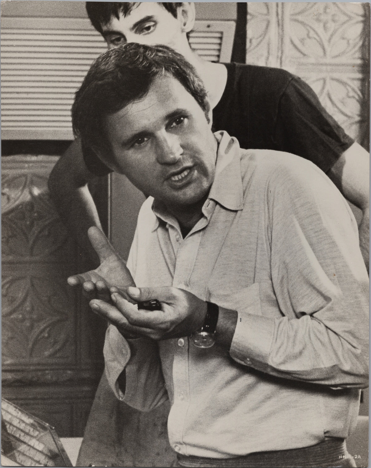 Man Gesturing During an Indoor Conversation — front