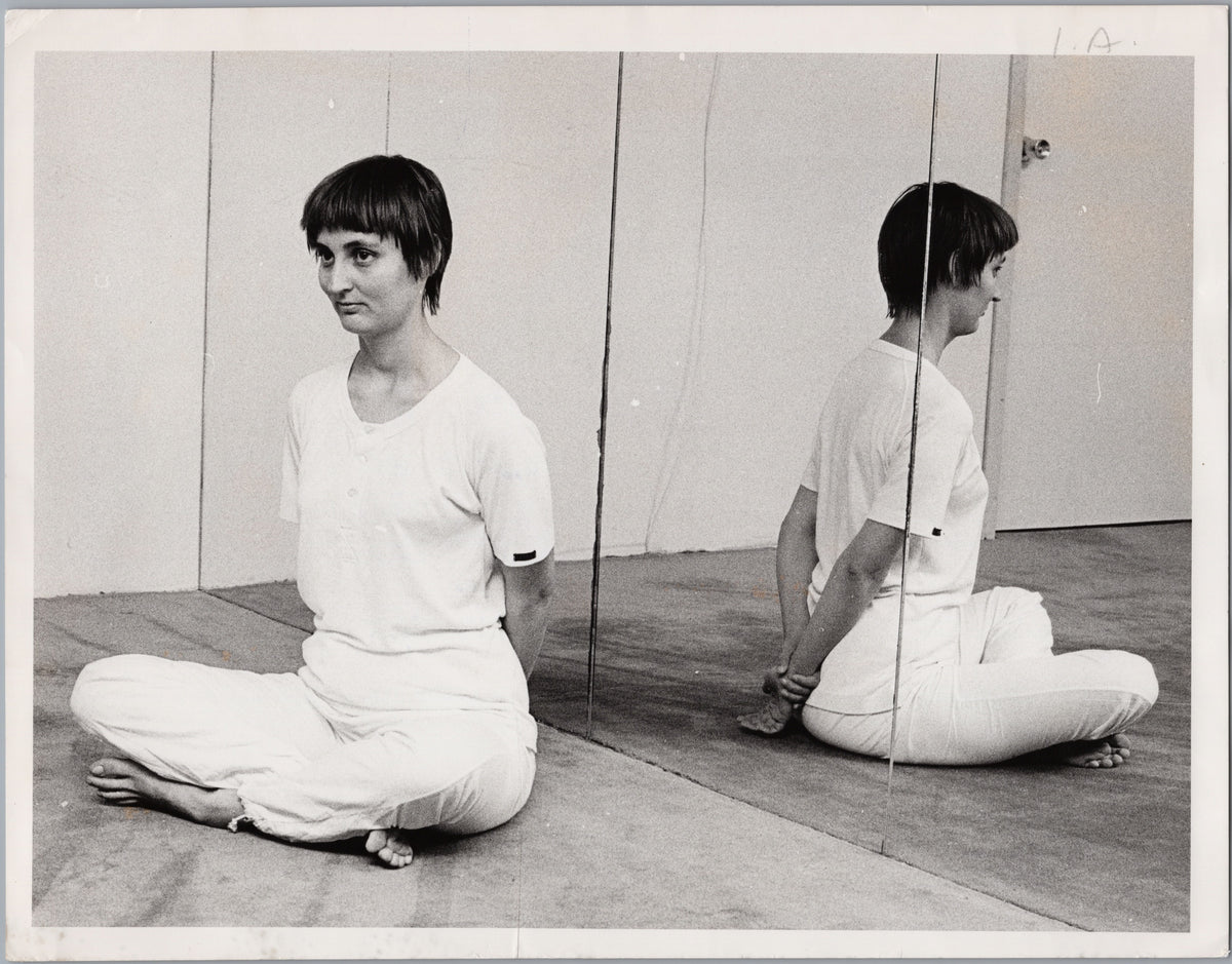 Seated Stretching Exercise Beside a Mirror — front