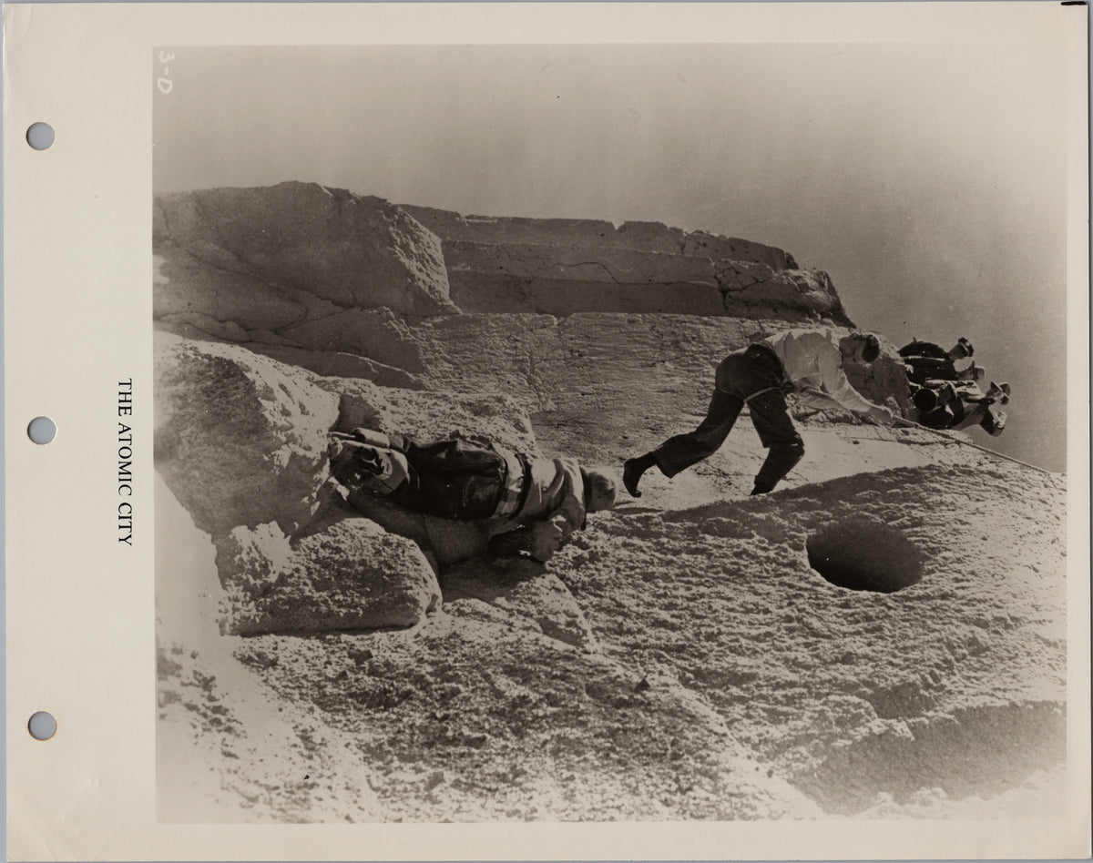The Atomic City — Climbers on a Rocky Cliff — front