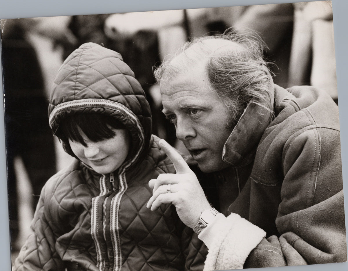 Man in a Coat Talking with a Hooded Child — front