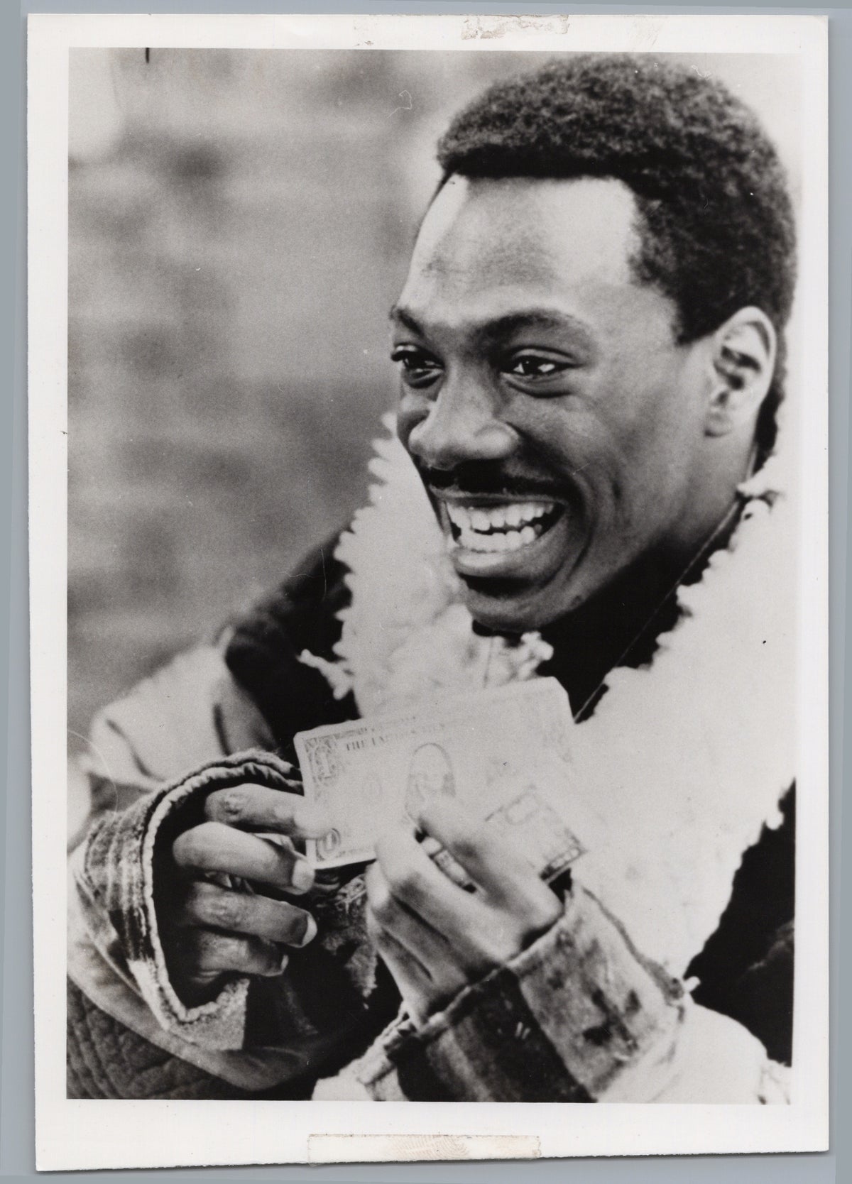 Eddie Murphy with a Garland of Banknotes — front