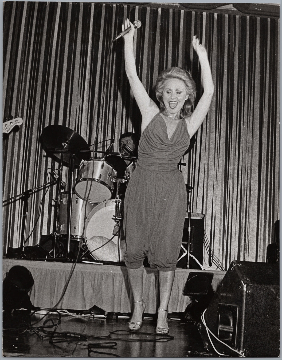 Lulu on Stage with Arms Raised — front