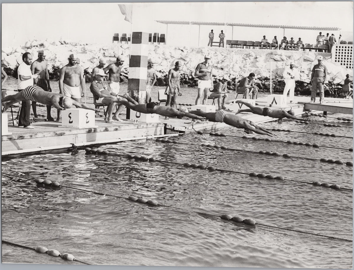 Swimmers Diving into an Outdoor Pool — front
