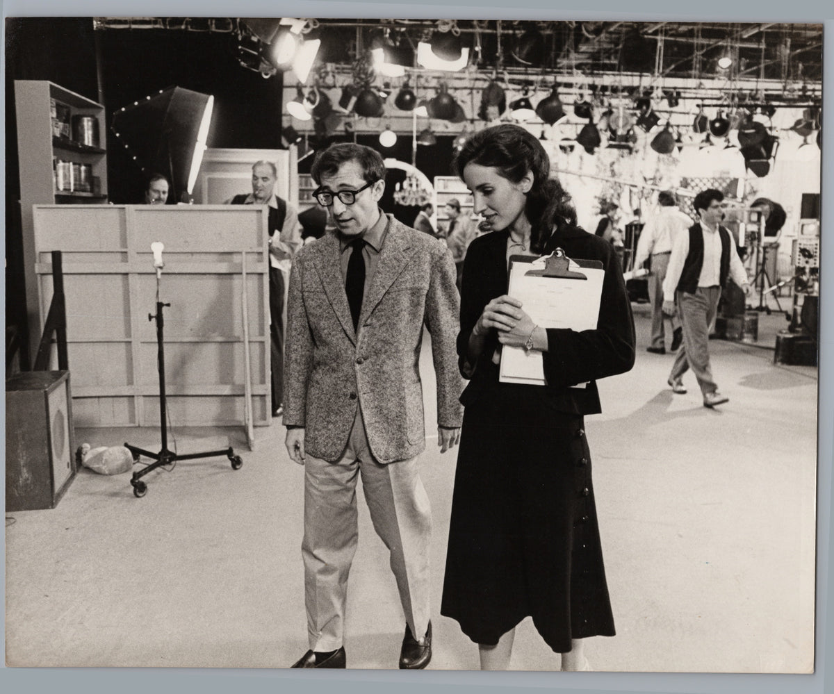 Two People Walking through a Film Studio — front
