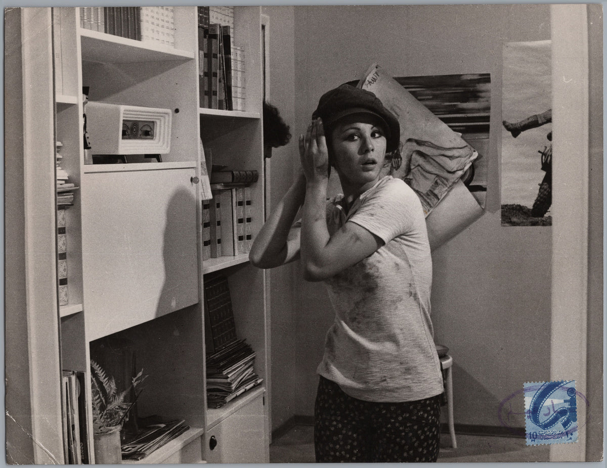 Woman Carrying a Bundle in a Storeroom — front