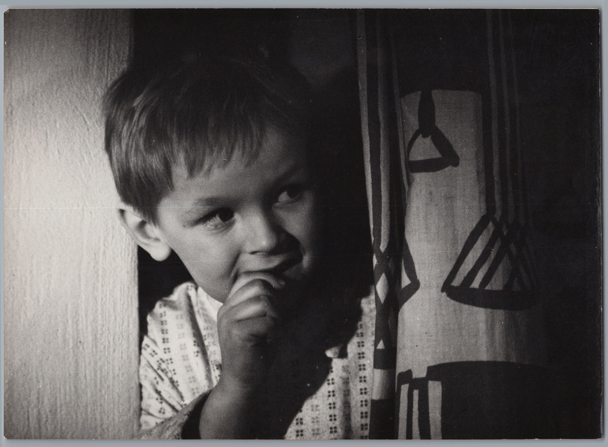 Child Beside a Patterned Curtain — front