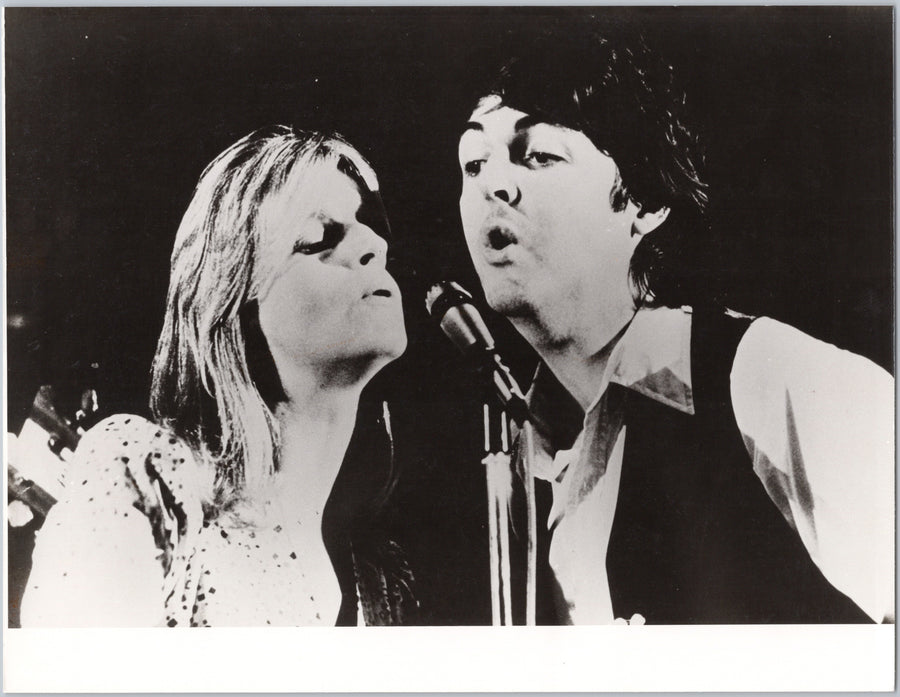Linda and Paul McCartney Singing at a Microphone