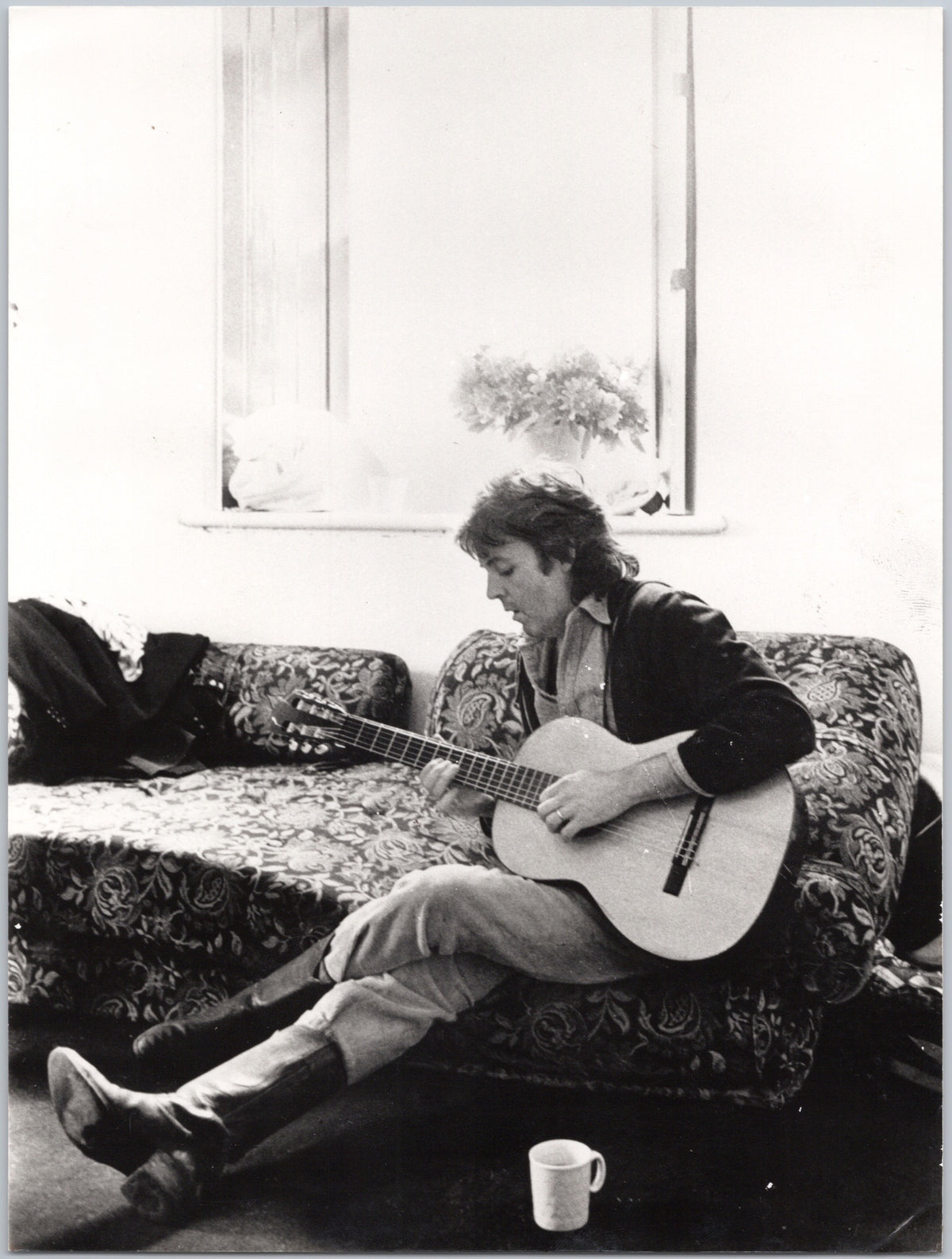 Paul McCartney Playing Acoustic Guitar on a Sofa — front