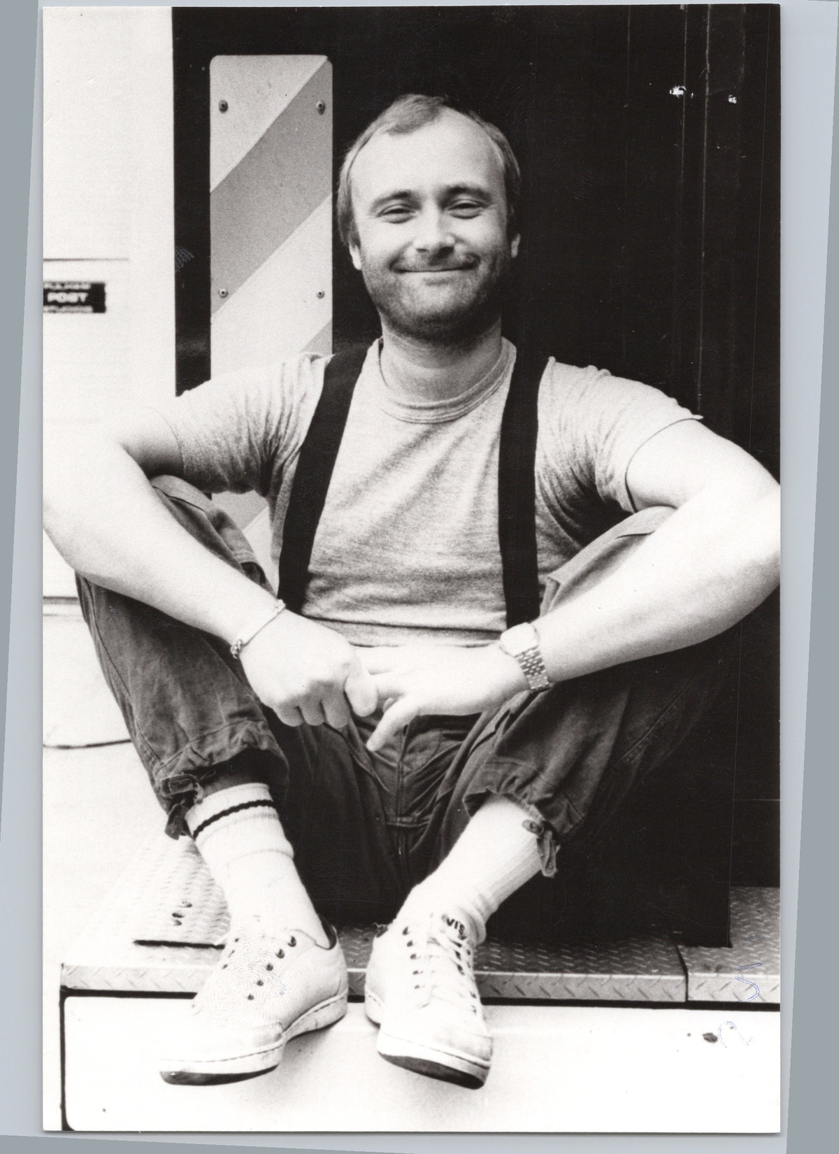 Phil Collins Seated on a Doorstep — front
