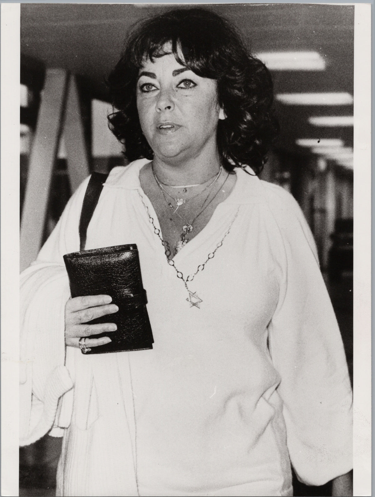 Elizabeth Taylor Holding a Small Booklet — front