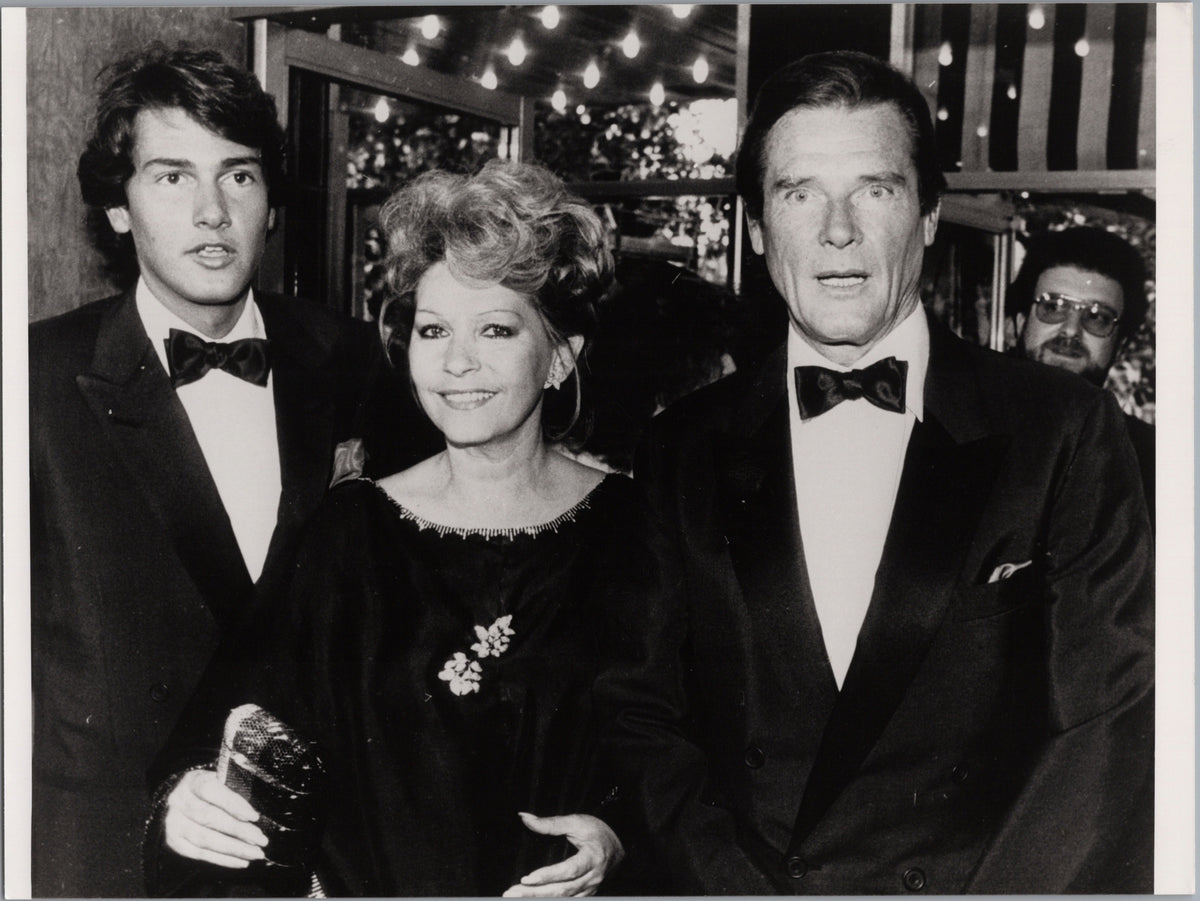 Roger Moore with Luisa and Geoffrey at a Formal Event — front