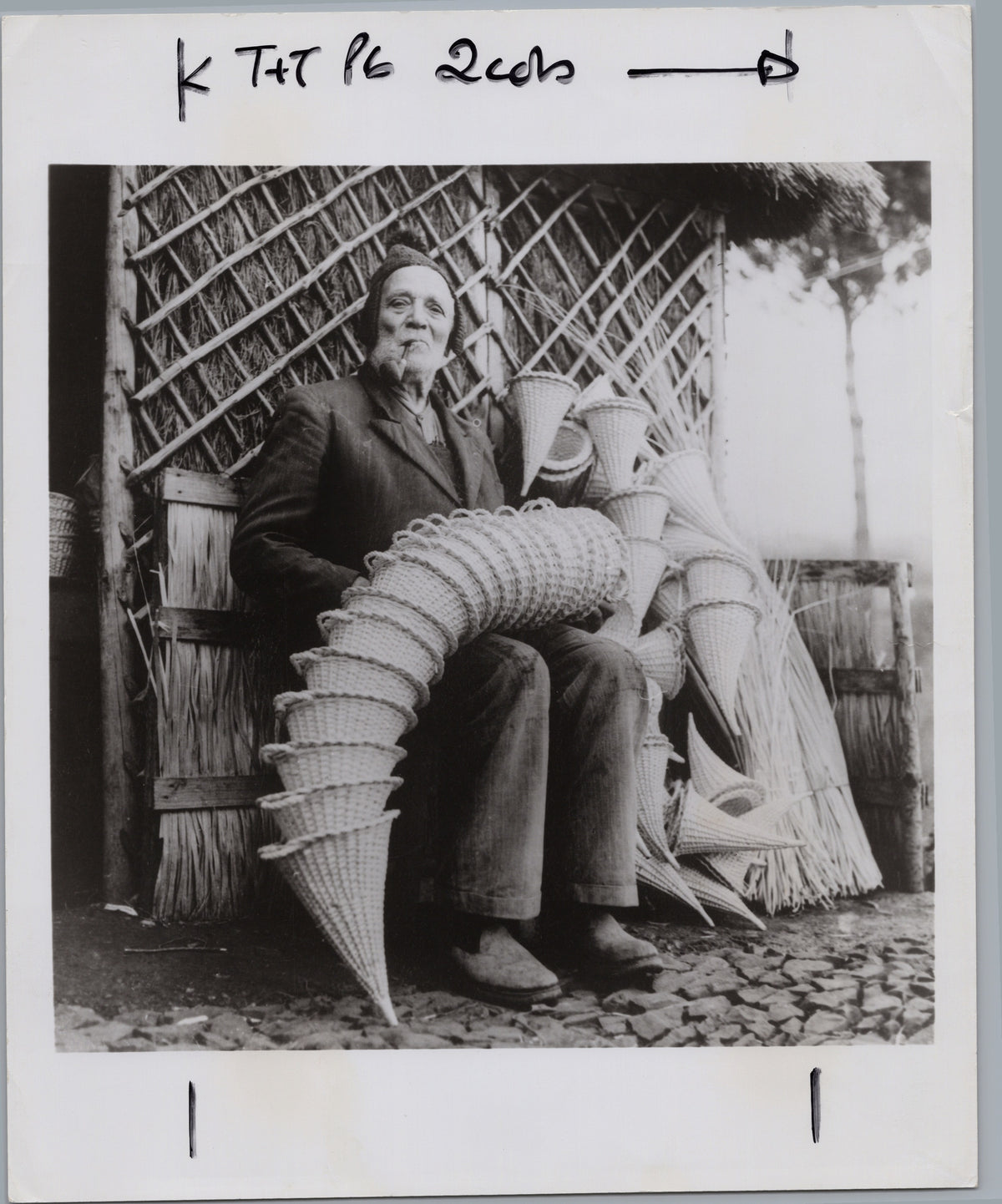 Man Seated Beside a Large Creature Prop — front