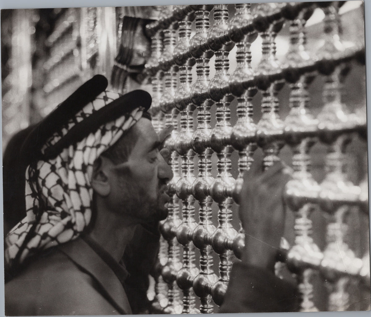 Man Beside an Ornate Metal Lattice — front