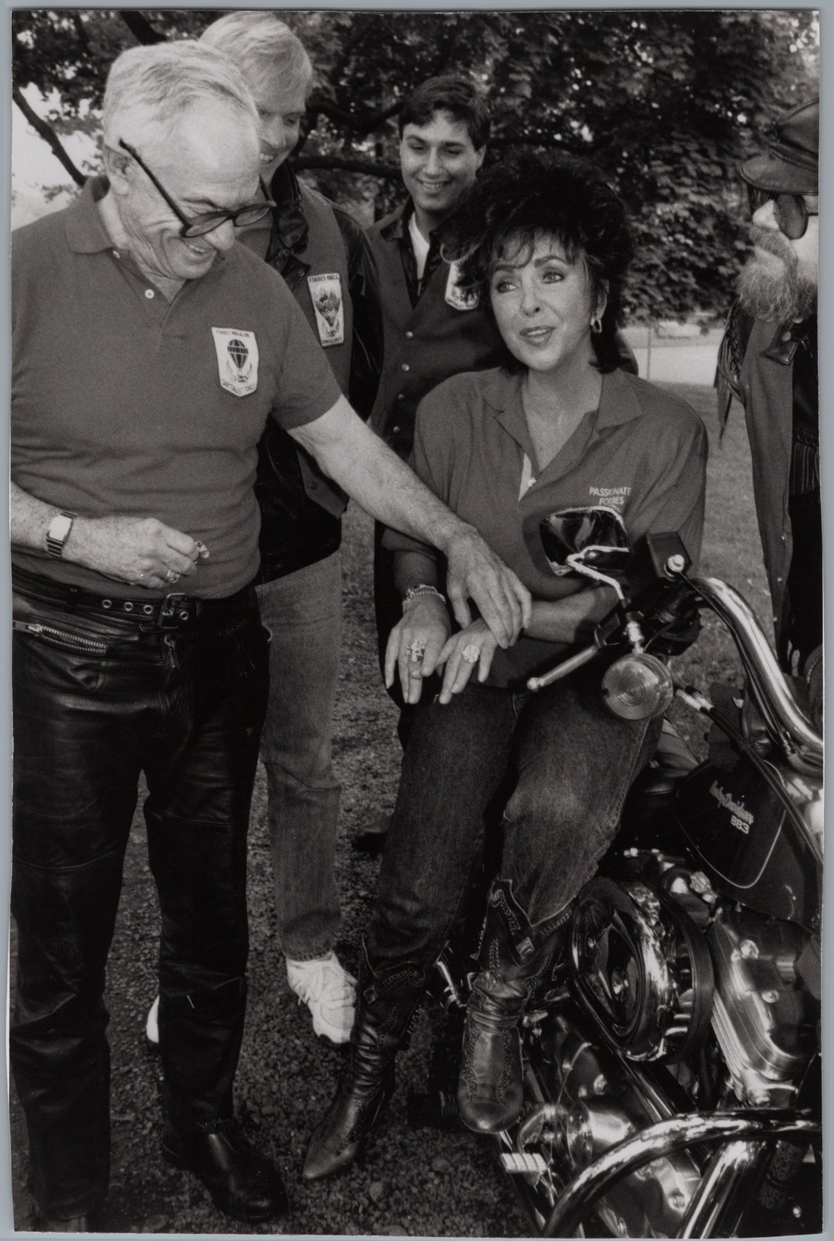 Malcolm Forbes and Elizabeth Taylor beside a Motorcycle — front